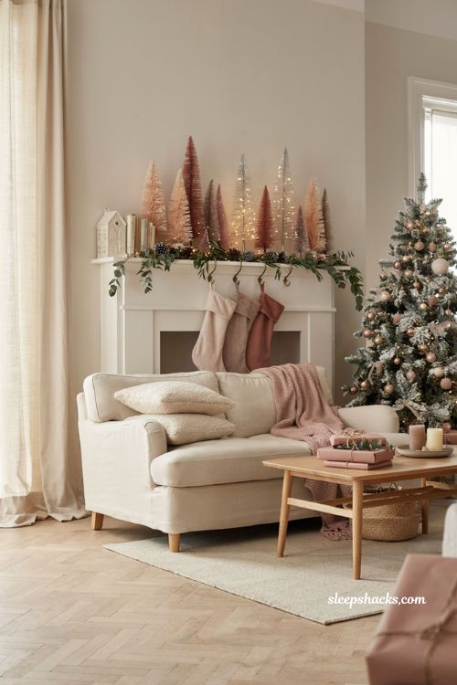 Pink christmas mantel decor with blush bottle brush trees and cozy holiday styling