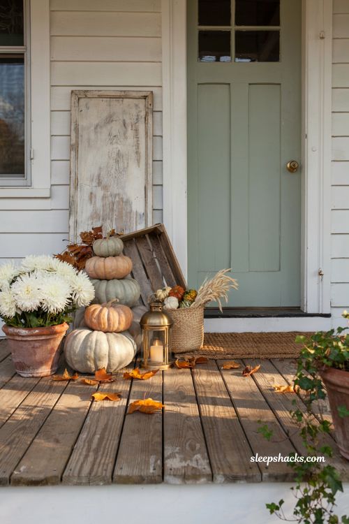 Pumpkin porch decor with a rustic wooden sign and layered fall pumpkins