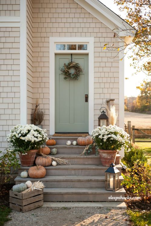 Pumpkin porch decor with a stair step pumpkin display on front porch steps