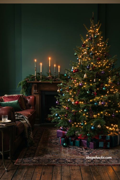 Rich jewel tone Christmas living room decor idea with emerald sapphire and ruby ornaments on a warm lit tree