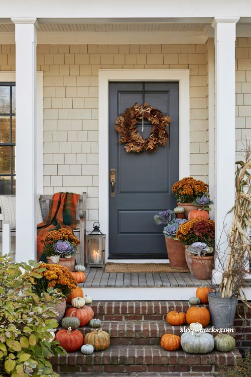 Rustic and cozy front porch with fall decor ideas using pumpkins and mums