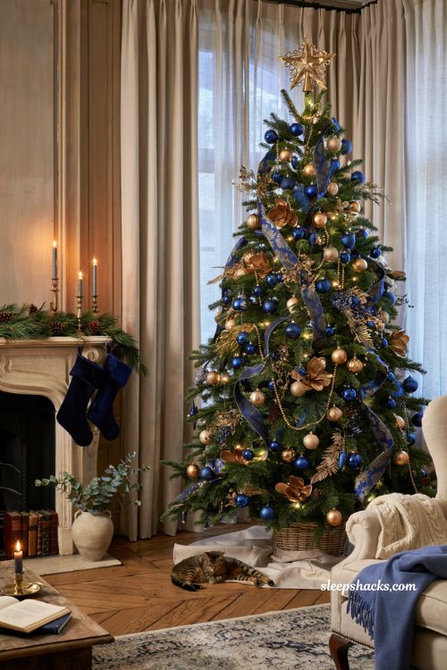 Sapphire and gold Christmas tree with regal blue holiday decor and elegant ribbon styling