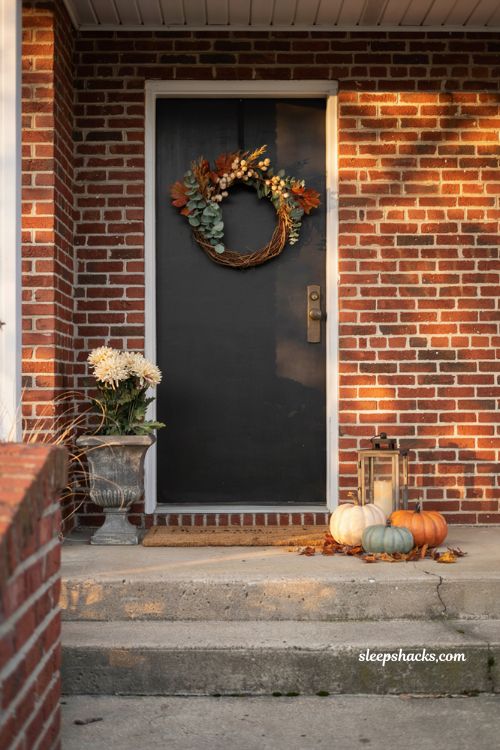 Simple fall porch decorating ideas for a small stoop with wreath pumpkins and cosy farmhouse entry