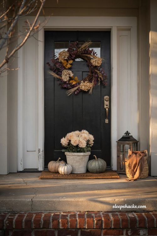 Simple fall porch decorating ideas with bold autumn wreath and cosy farmhouse front entry