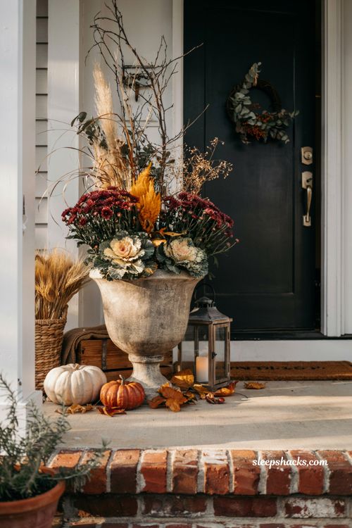 Small front porch fall decor ideas with autumn planter overflowing with mums celosia and cosy farmhouse styling
