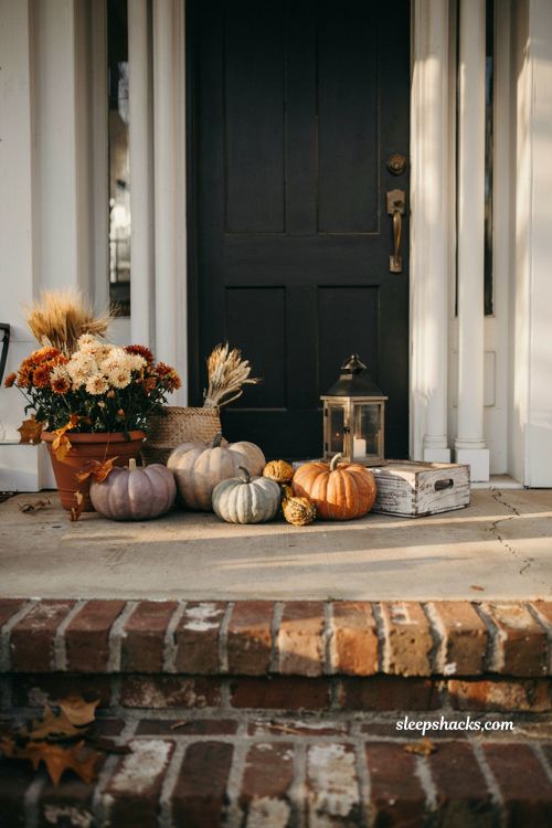 Small front porch fall decor ideas with hand painted pumpkins and cosy farmhouse autumn styling