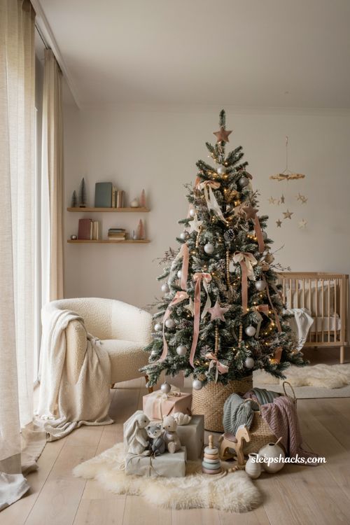 Snow flocked pink and silver nursery Christmas tree with soft winter fairy decor ideas