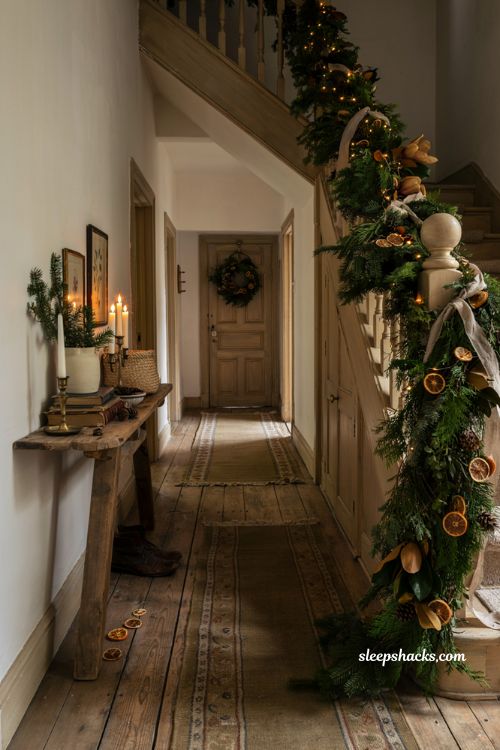 Timeless christmas decor with faux garland dried oranges and magnolia leaves on a cozy staircase