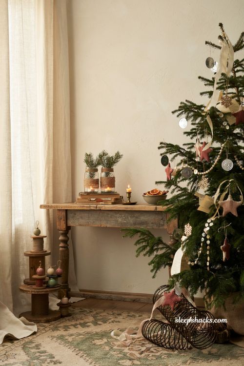 Upcycled christmas decorations with handmade recycled ornaments in a cozy rustic holiday living room
