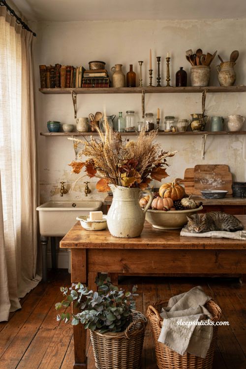 Vintage fall decor ideas with antique ironstone pitchers and bowls in a cozy farmhouse kitchen