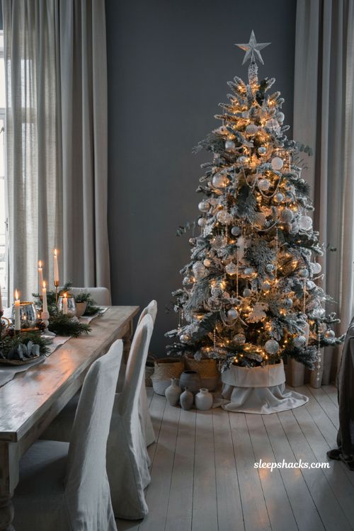 White and silver flocked Christmas tree with elegant winter dining room holiday decor ideas