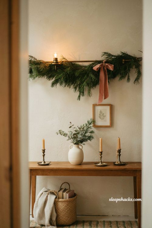 christmas wall sconce decor ideas with pine swag and velvet ribbon for a cozy hallway