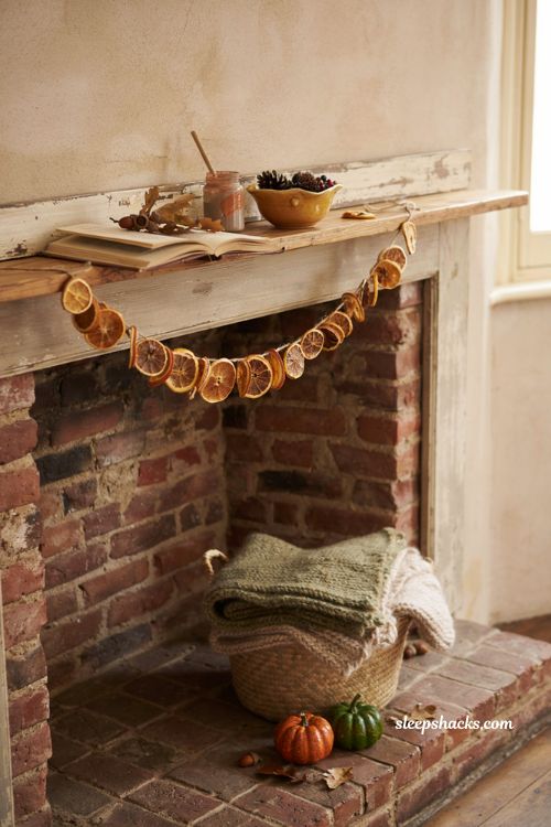 diy fall decor fireplace mantel with homemade painted pumpkins dried oranges and acorns alt text