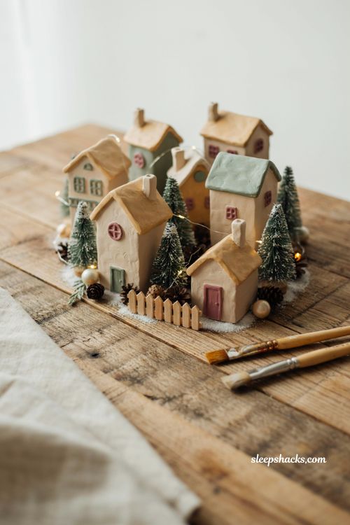 Air dry clay miniature Christmas village houses with handmade imperfect cottages and cozy winter decor 