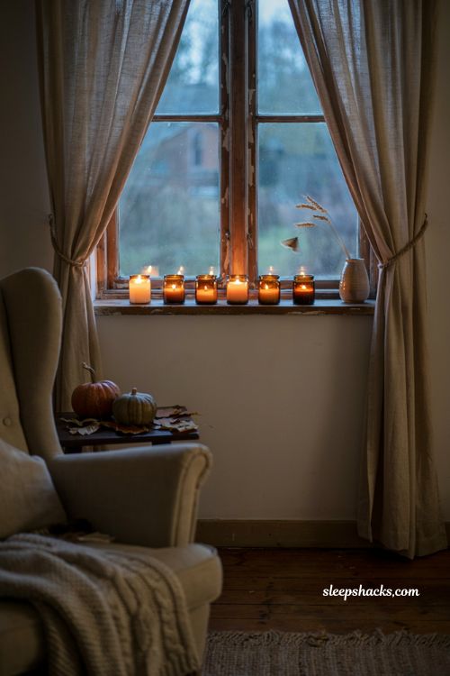 Amber glass votive candles along a cozy fall windowsill