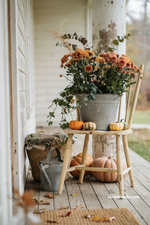 Antique chair plant stand with pumpkins and fall planter for a cozy porch 