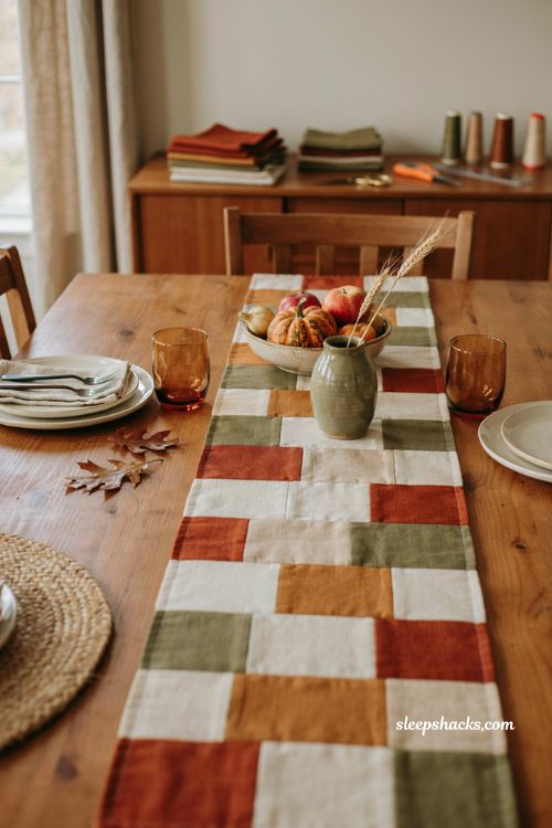 Autumn splendor fall table runner with rust olive and cream quilt blocks cozy farmhouse dining table