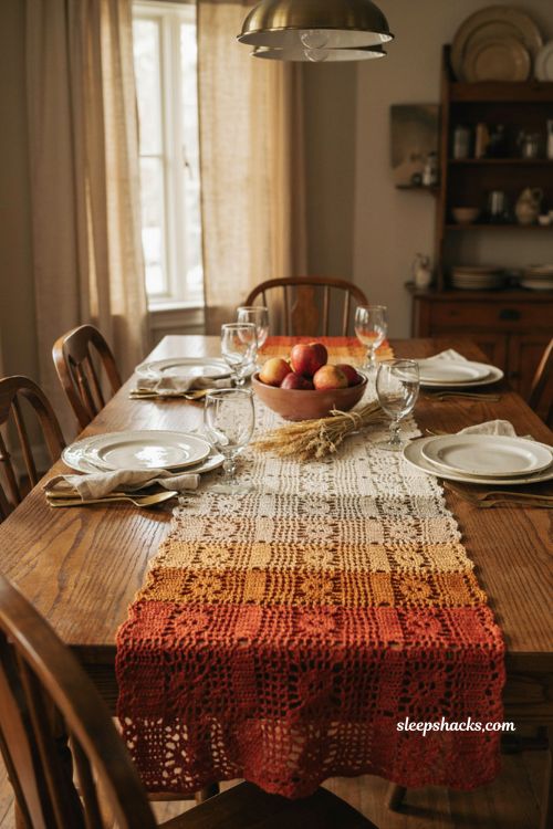 Autumn tones crochet table runner with cream amber and brick red stripes filet crochet lace pattern and elegant fall dining table 