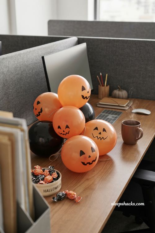 Balloon pumpkins filled with candy for fun office Halloween desk decor