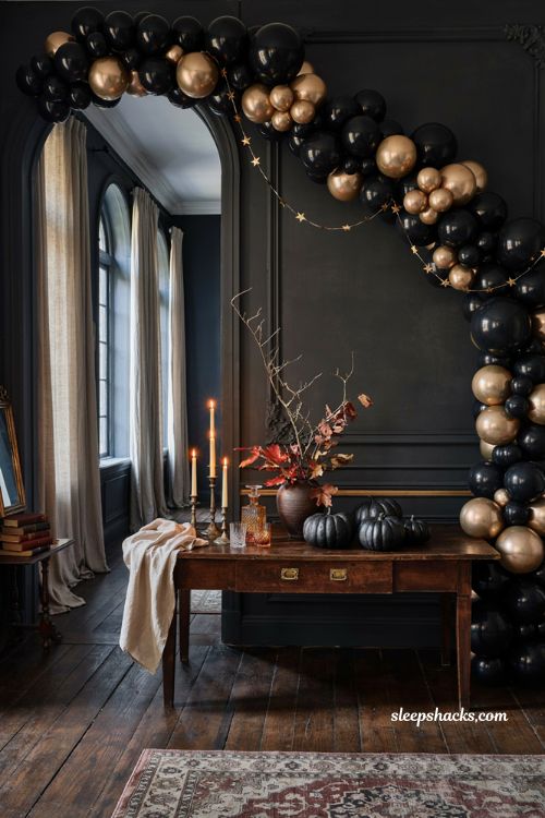 Black and gold Halloween balloon garland with elegant adult party decor and warm candlelight