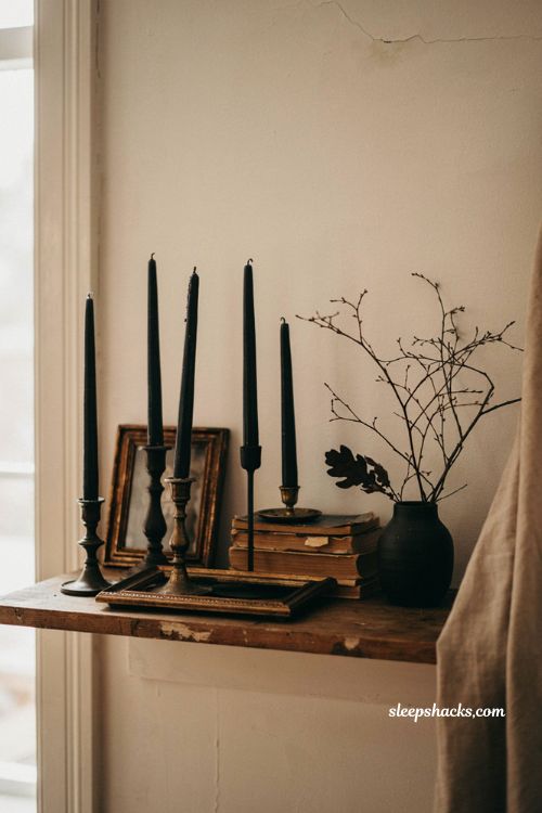 Black candles in black candlesticks for a simple spooky Halloween mantel 