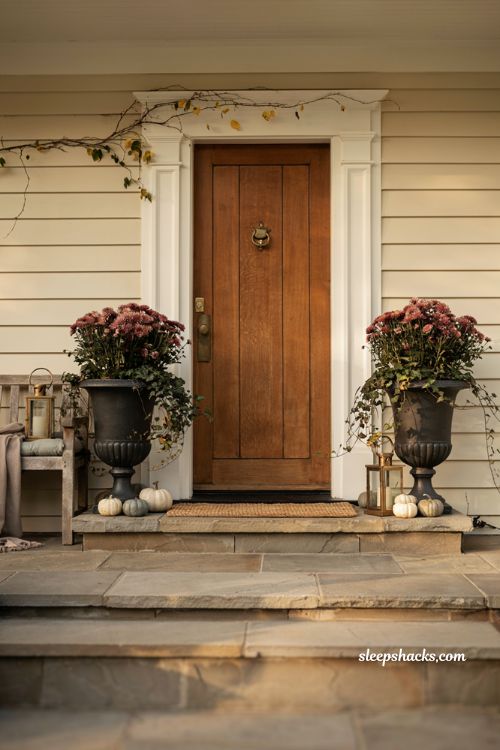 Black urn fall flower pots with draping ivy for elegant front porch decor