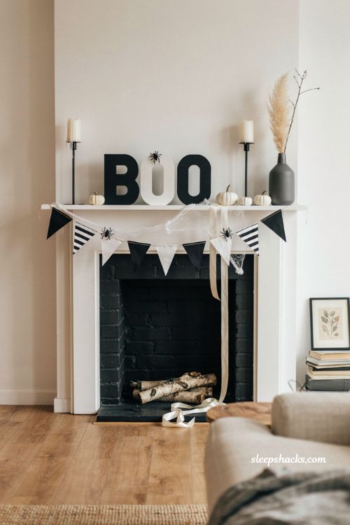 Bold monochrome Halloween mantel decor with black and white spooky accents