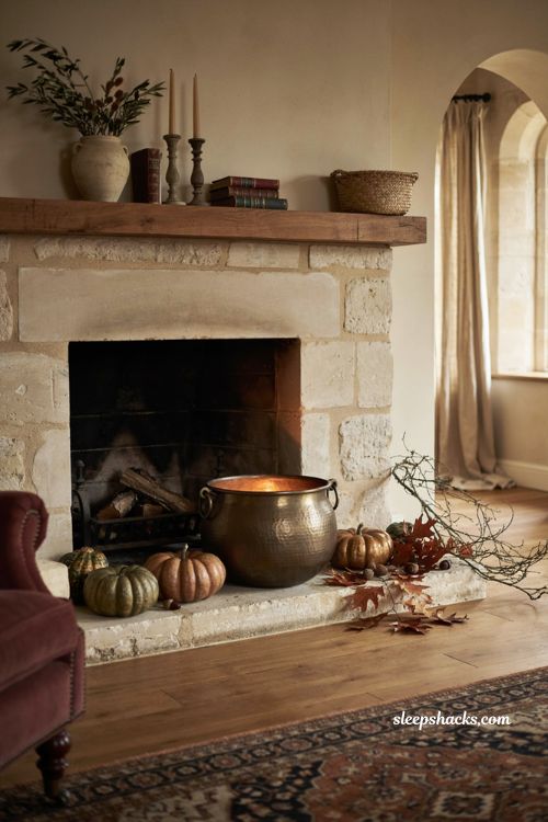 Brass cauldron with autumn pumpkins for subtle Halloween fireplace decor