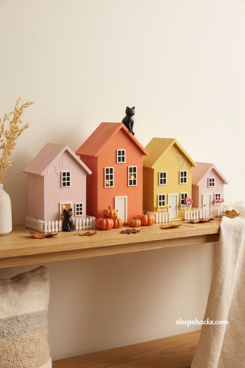 Bright ombre Halloween village with pink orange and yellow wood block houses 
