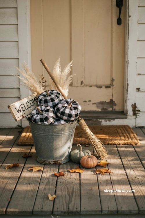 Buffalo check fabric pumpkins in a galvanized bucket for farmhouse Halloween decor 