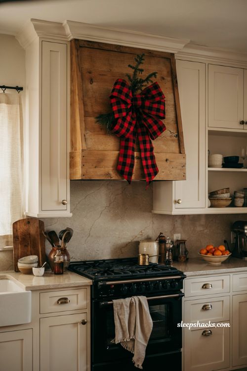 Buffalo plaid Christmas bow on farmhouse kitchen range hood with greenery
