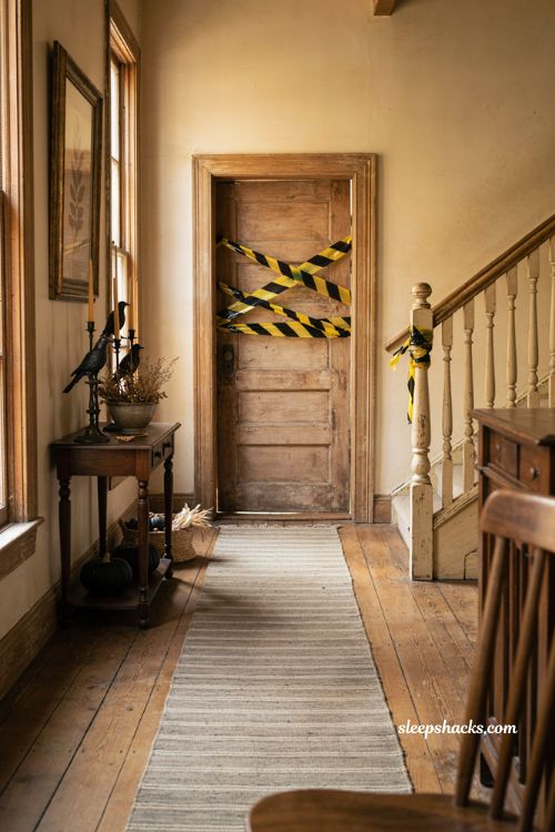 Caution tape accents for a cheap spooky Halloween entryway 