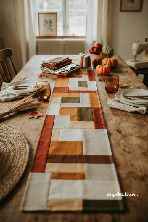 Center pieces fall table runner with autumn quilted fabric strips cozy farmhouse dining table and sewing supplies