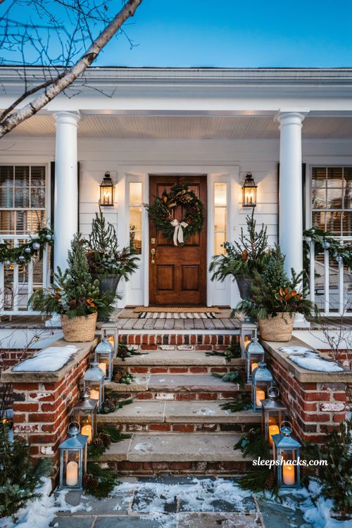 Christmas front porch steps lined with galvanized lanterns and evergreen accents