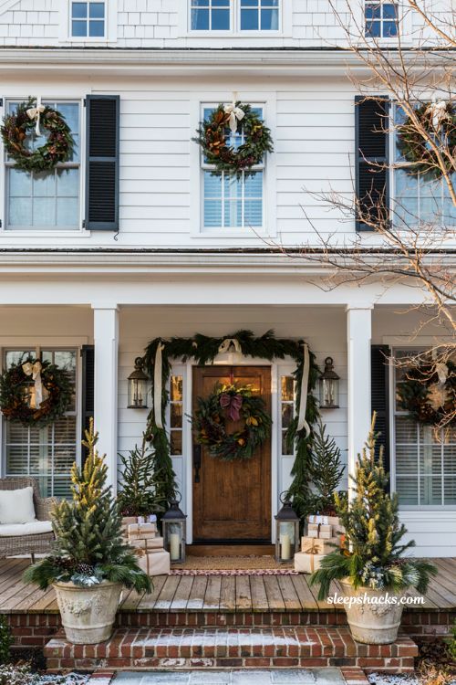 Christmas front porch with wreaths on every window and classic holiday curb appeal