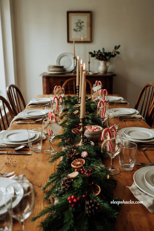 Christmas tablescape with candy cane place card holders peppermint and greenery