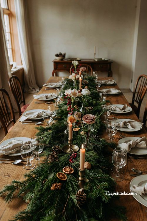 Christmas tablescape with evergreen garland bud vases and simple floral centerpiece
