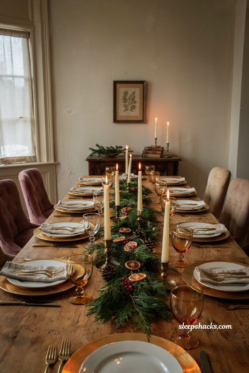 Christmas tablescape with gold charger plates white dinnerware and candlelight