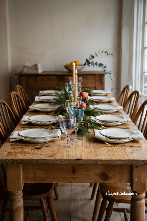Christmas tablescape with iridescent glassware evergreen centerpiece and candlelight