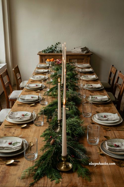 Christmas tablescape with matching taper candles and loose evergreen garland