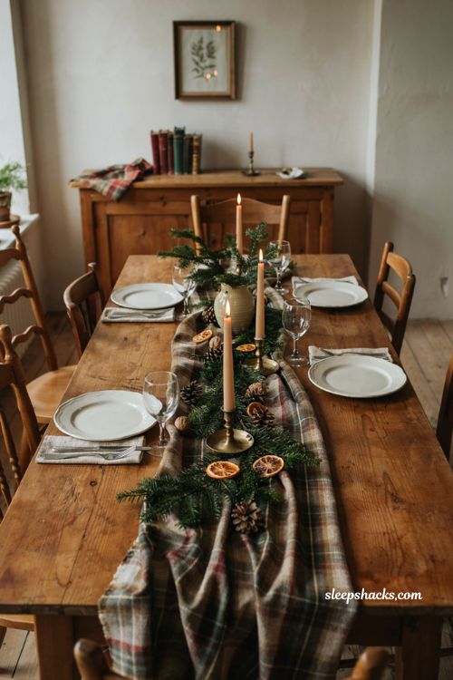 Christmas tablescape with plaid scarf runner candles and evergreen greenery