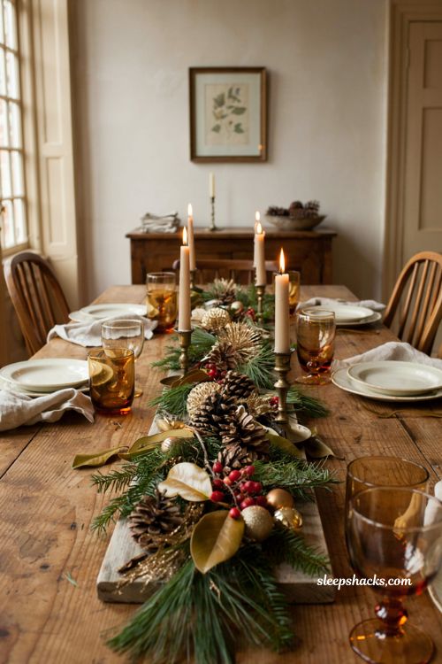 Christmas tablescape with spray painted pinecones magnolia leaves and gold foliage
