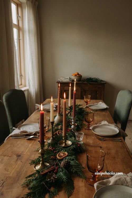 Christmas tablescape with taper candles at varying heights brass ceramic and glass holders