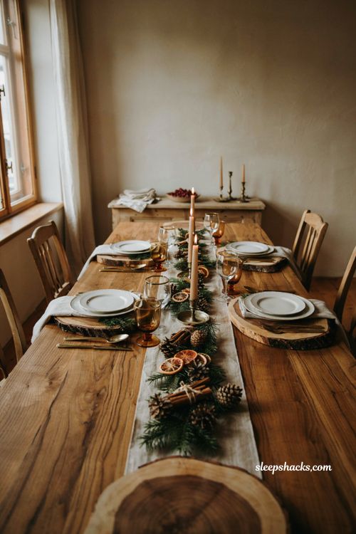 Christmas tablescape with wood slice chargers white plates linen napkins and greenery
