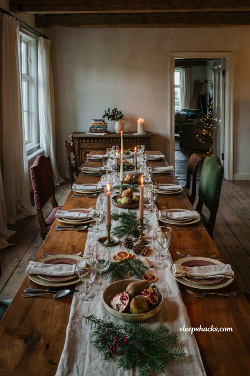 Christmas tablescapes ideas with candlelight pine greenery gold flatware and linen runner
