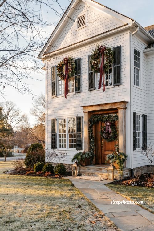 Christmas windows with cedar and magnolia swags above each window