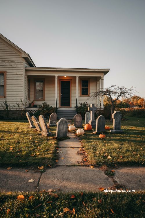 Classic Halloween graveyard tombstone cluster with moss fallen leaves and cozy front yard decor