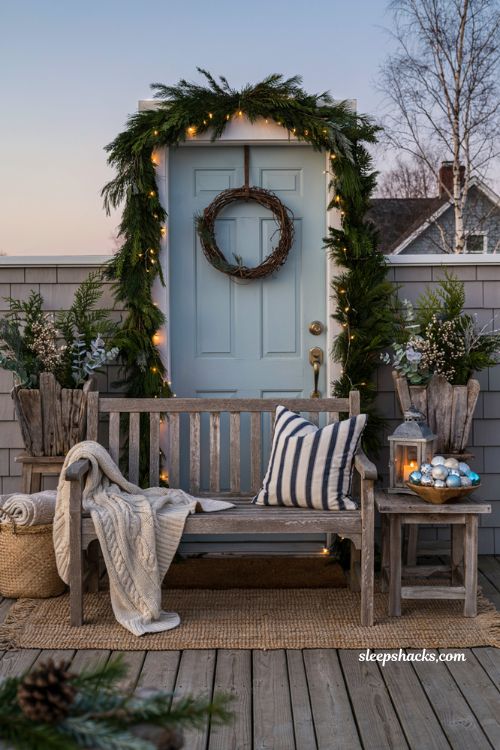 Coastal christmas porch decor ideas with cozy seating vignette and knit throw blanket