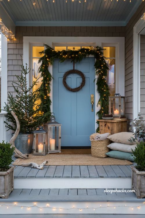 Coastal christmas porch decor ideas with layered battery lanterns for cozy evening glow
