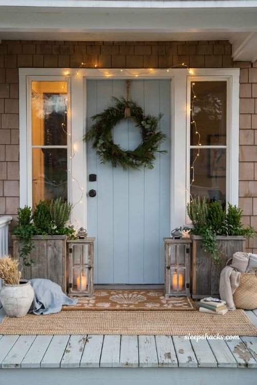 Coastal christmas porch decor ideas with layered coastal print doormat and jute rug 